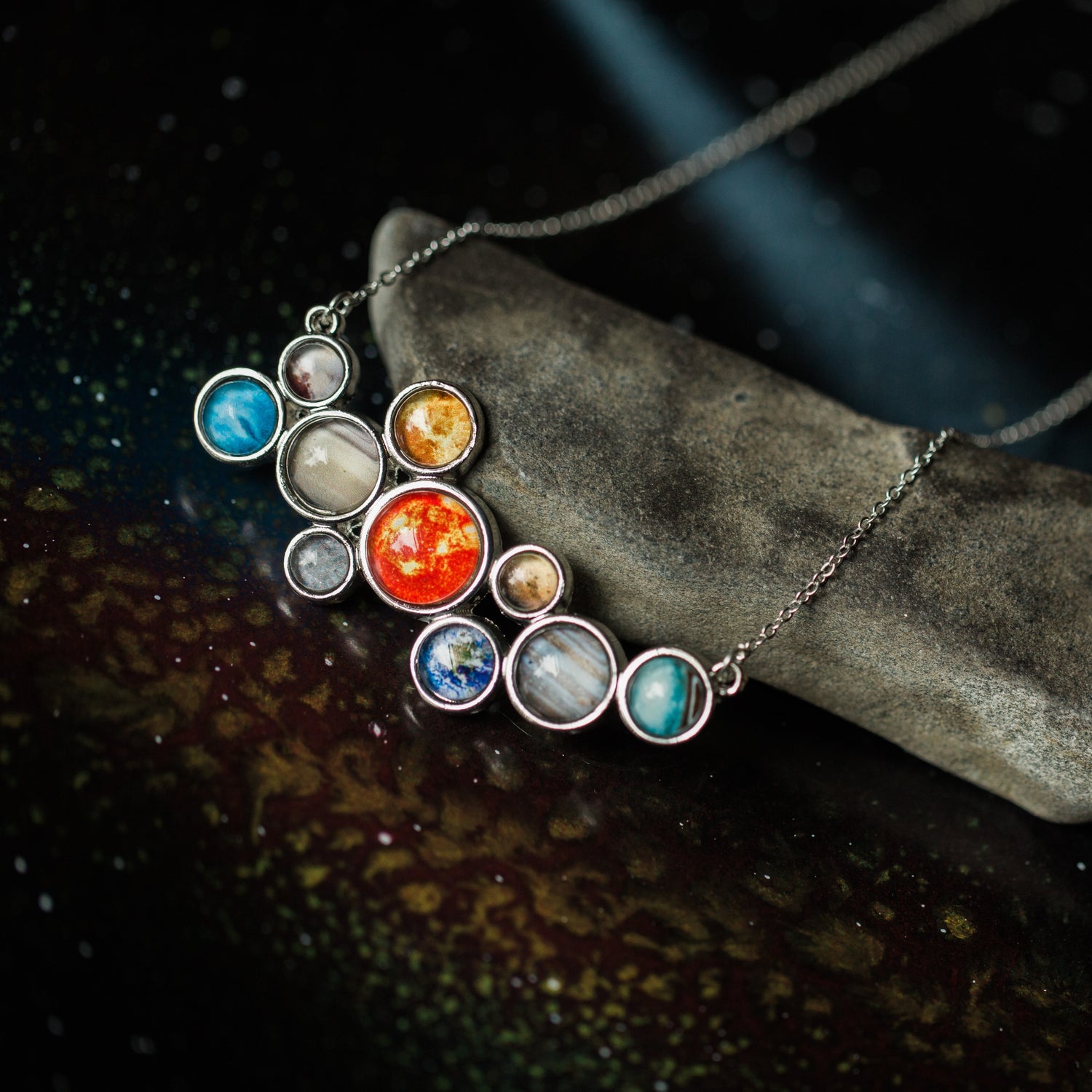 A pendant with the Sun and planets of our solar system in a bubble formation