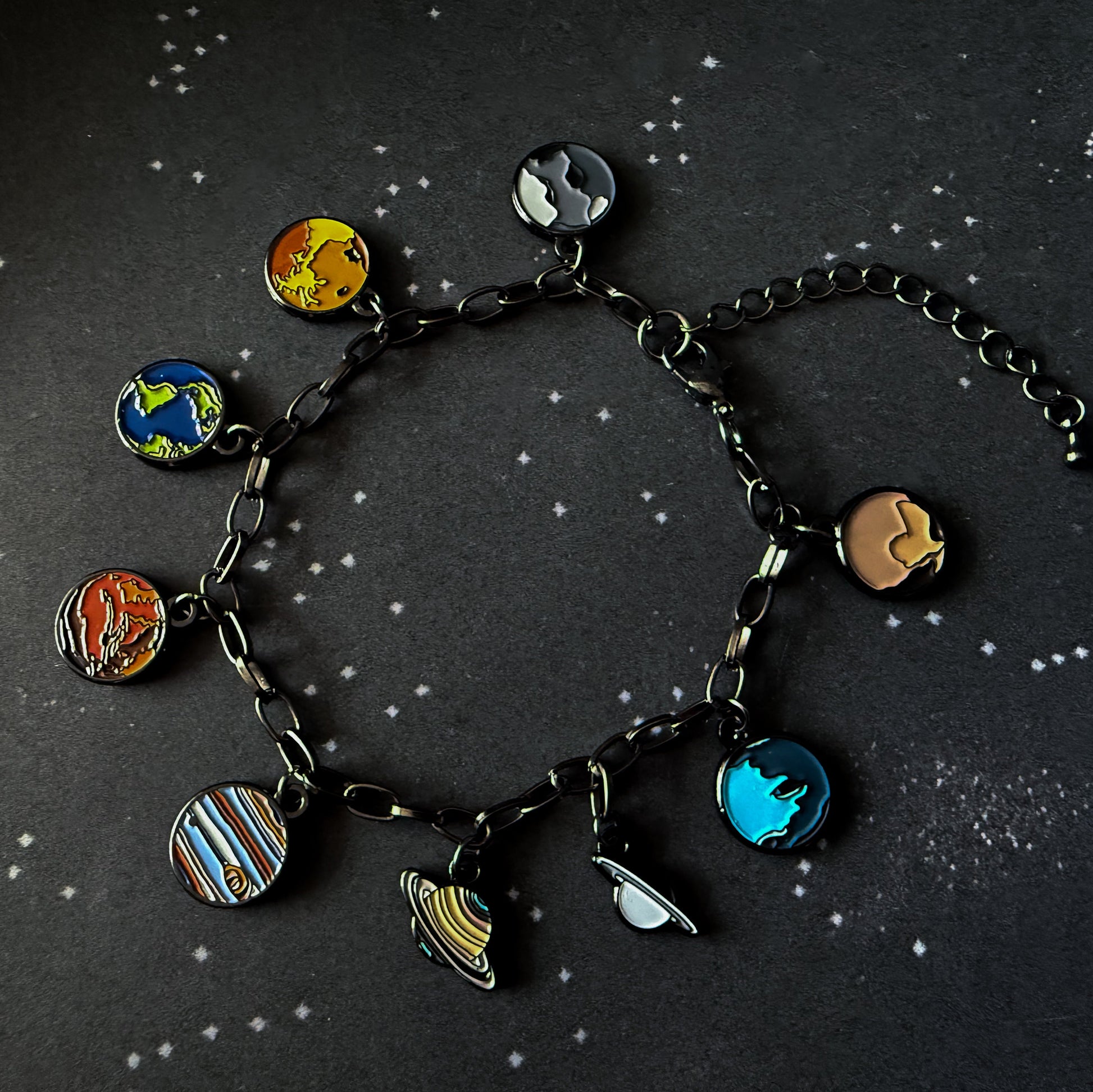 Bracelet with planet charms on a starry background