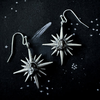 Supernova Starburst Dangle Earrings with Authentic Meteorite on a dark space background