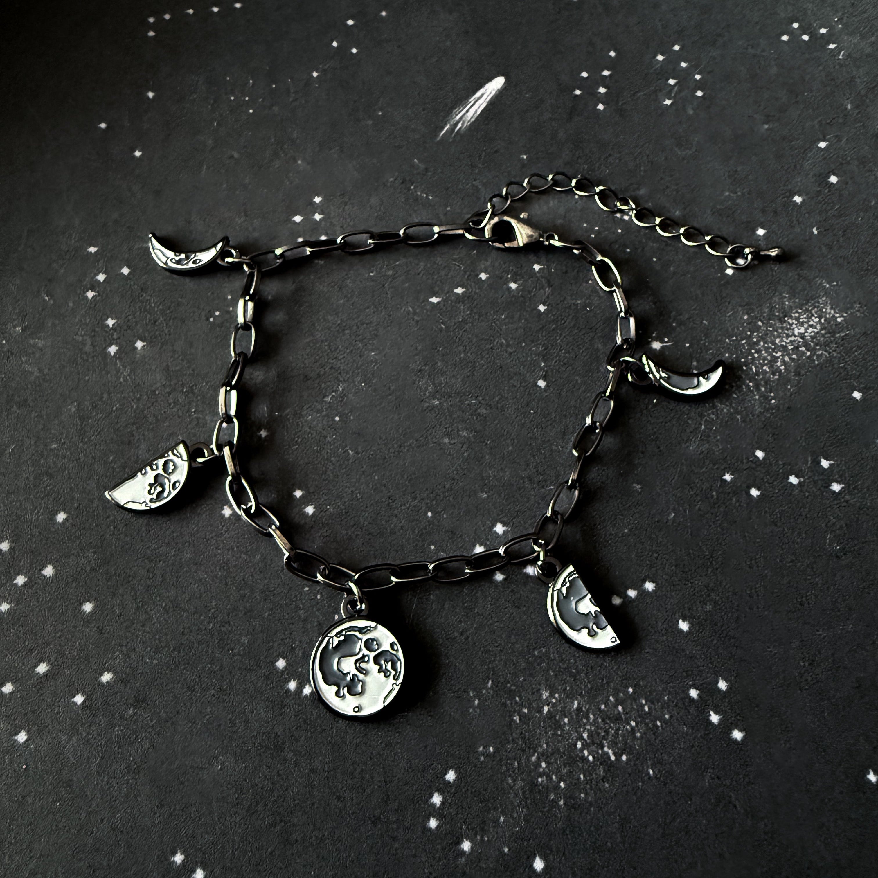 Bracelet with moon charms on a dark background