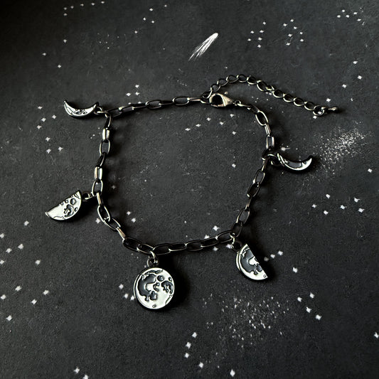 Bracelet with moon charms on a dark background