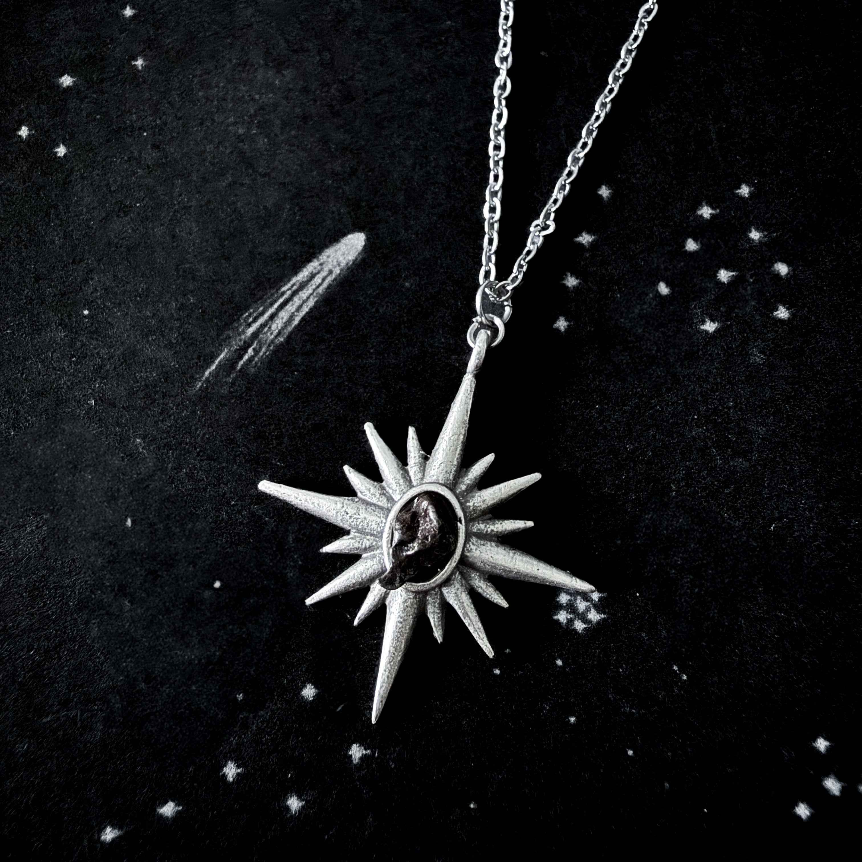 Silver star-shaped pendant necklace on a dark background