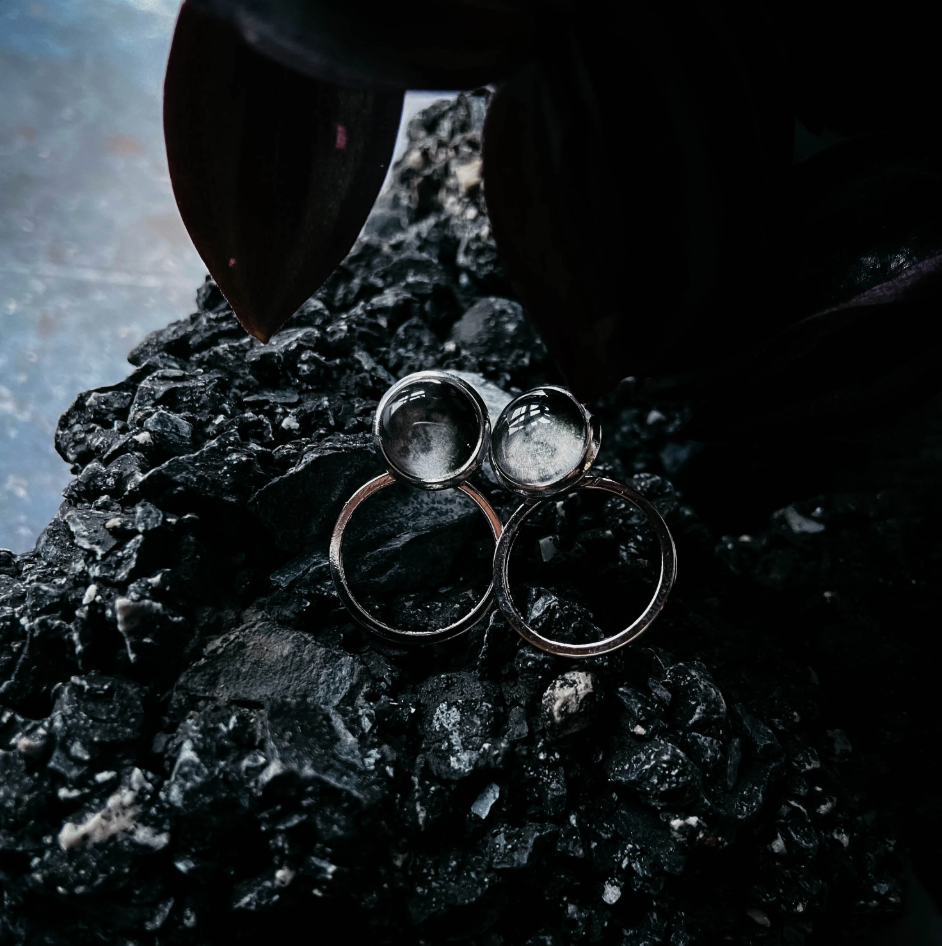 Circle ear jacket earring sitting on a dark rock