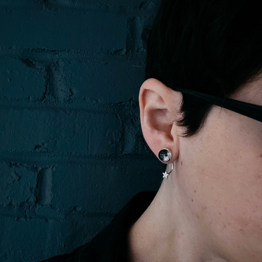 Woman wearing a my moon star ear jacket earring with head tilted.